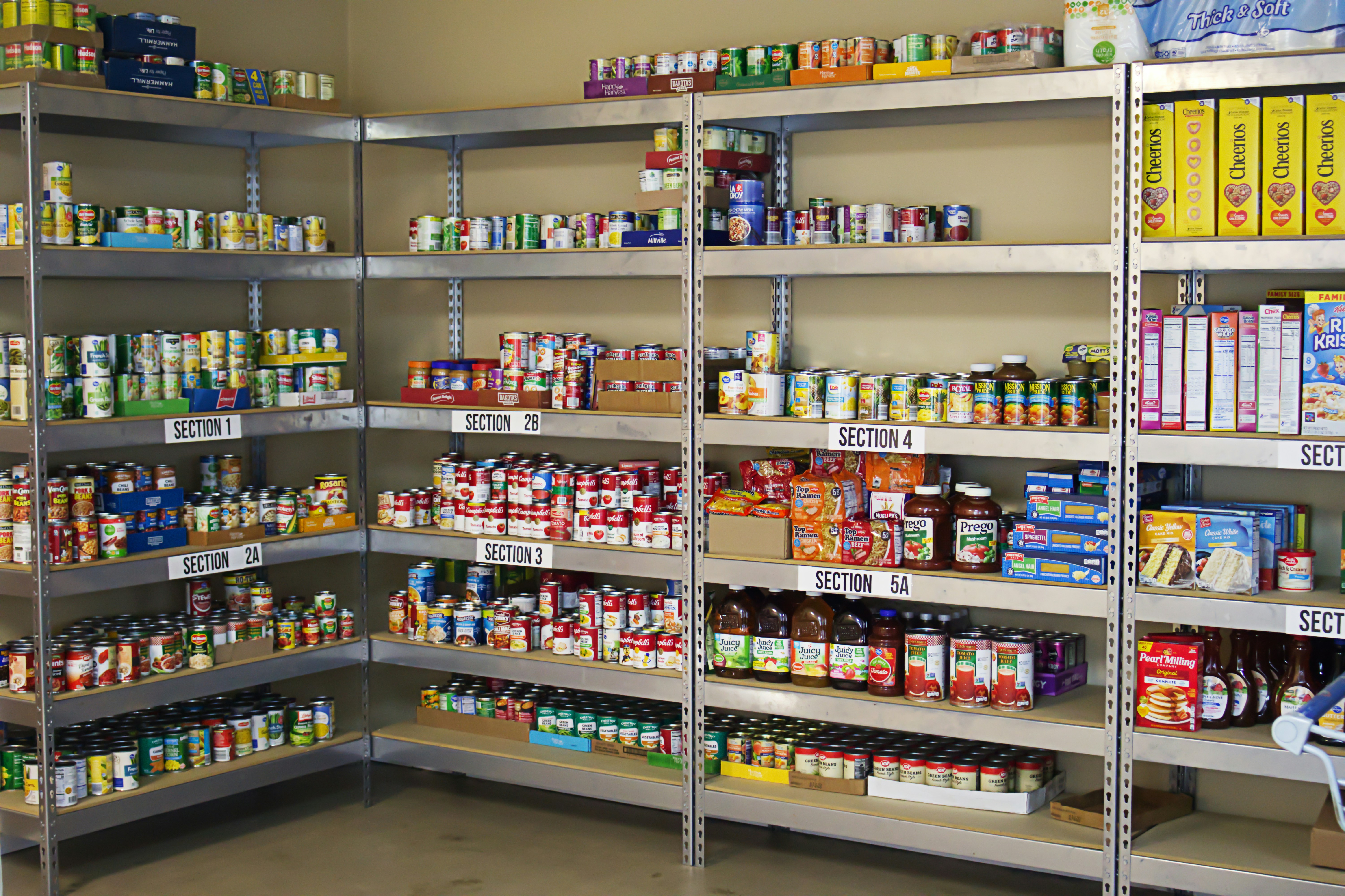 Food bank warehouse shelves with labeled inventory